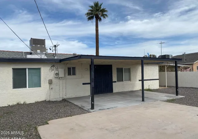 a view of a house with a backyard and garage