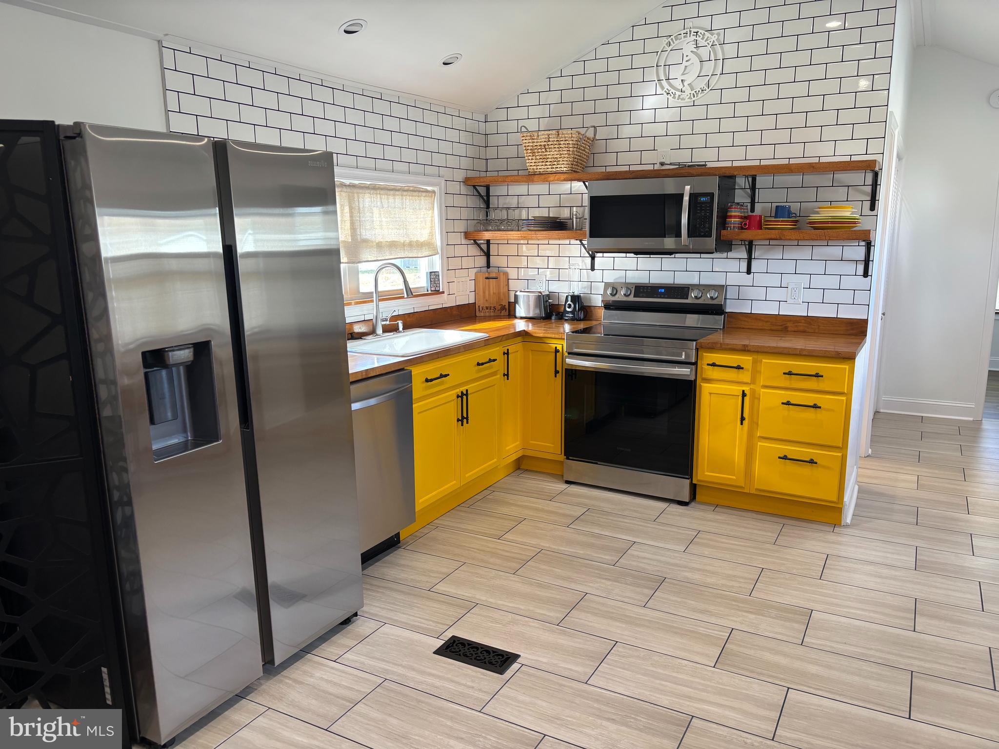 31752 Siham Road Lewes, DE 19958 - Photo 11 of 18 a kitchen with stainless steel appliances granite countertop a refrigerator a stove and a sink