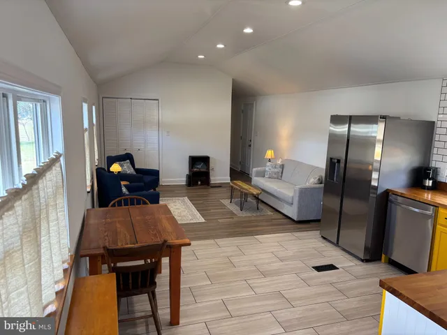 a living room with furniture and a dining table