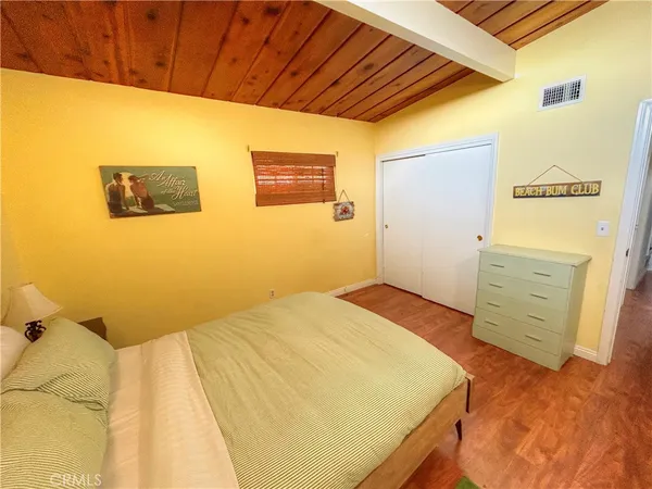 a bedroom with a bed and a dresser