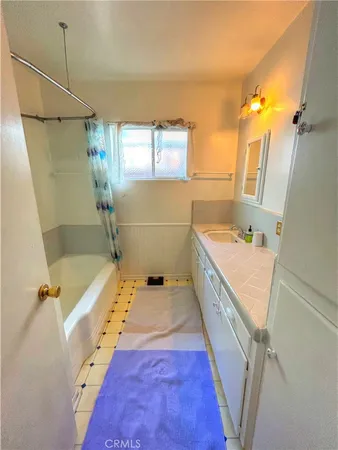 a bathroom with a tub sink and mirror