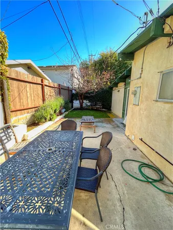 a backyard of a house with table and chairs