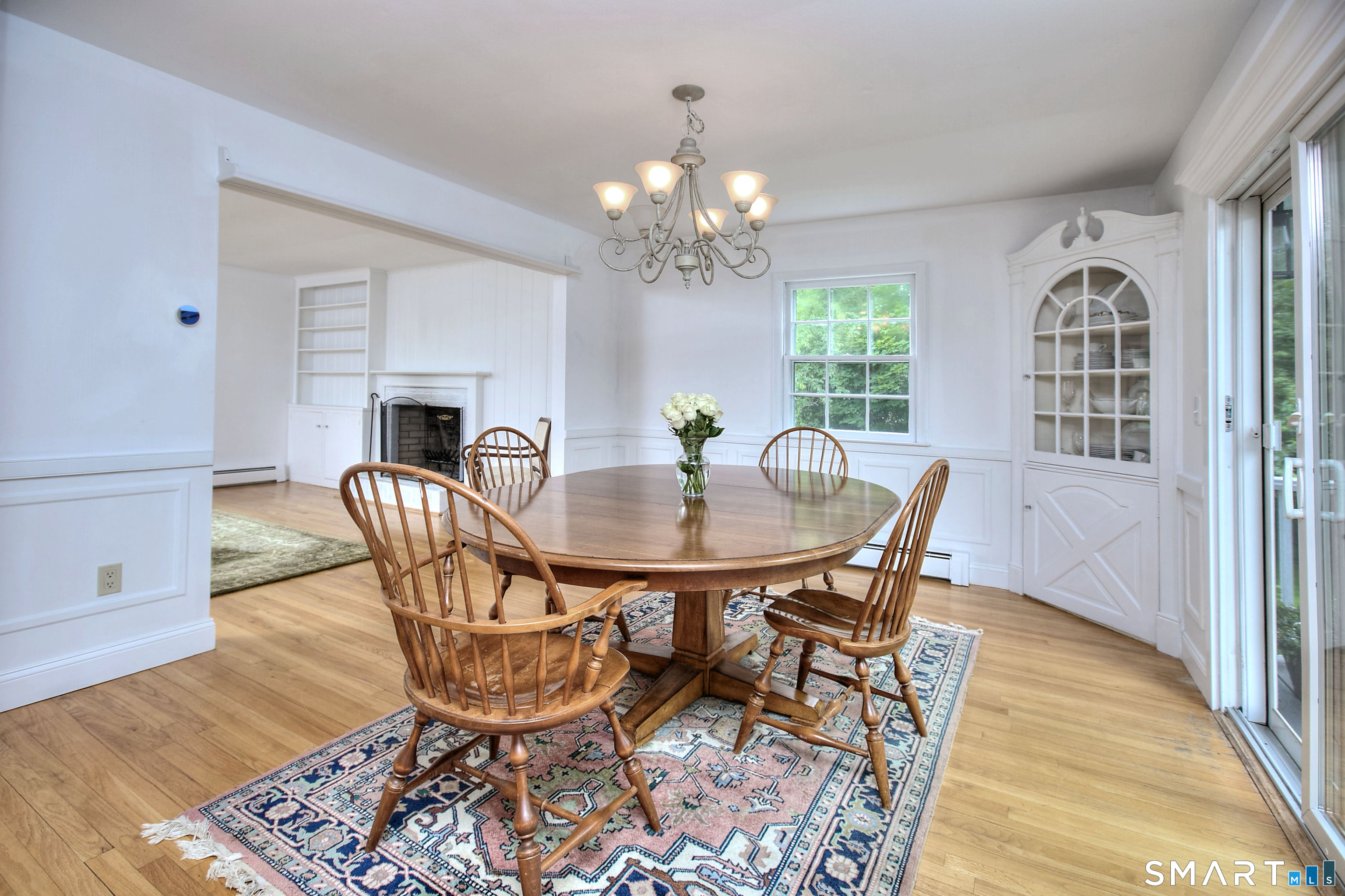 324 Ridge Road Orange, CT 06477 - Photo 8 of 38 a view of a dining room with furniture a chandelier and wooden floor