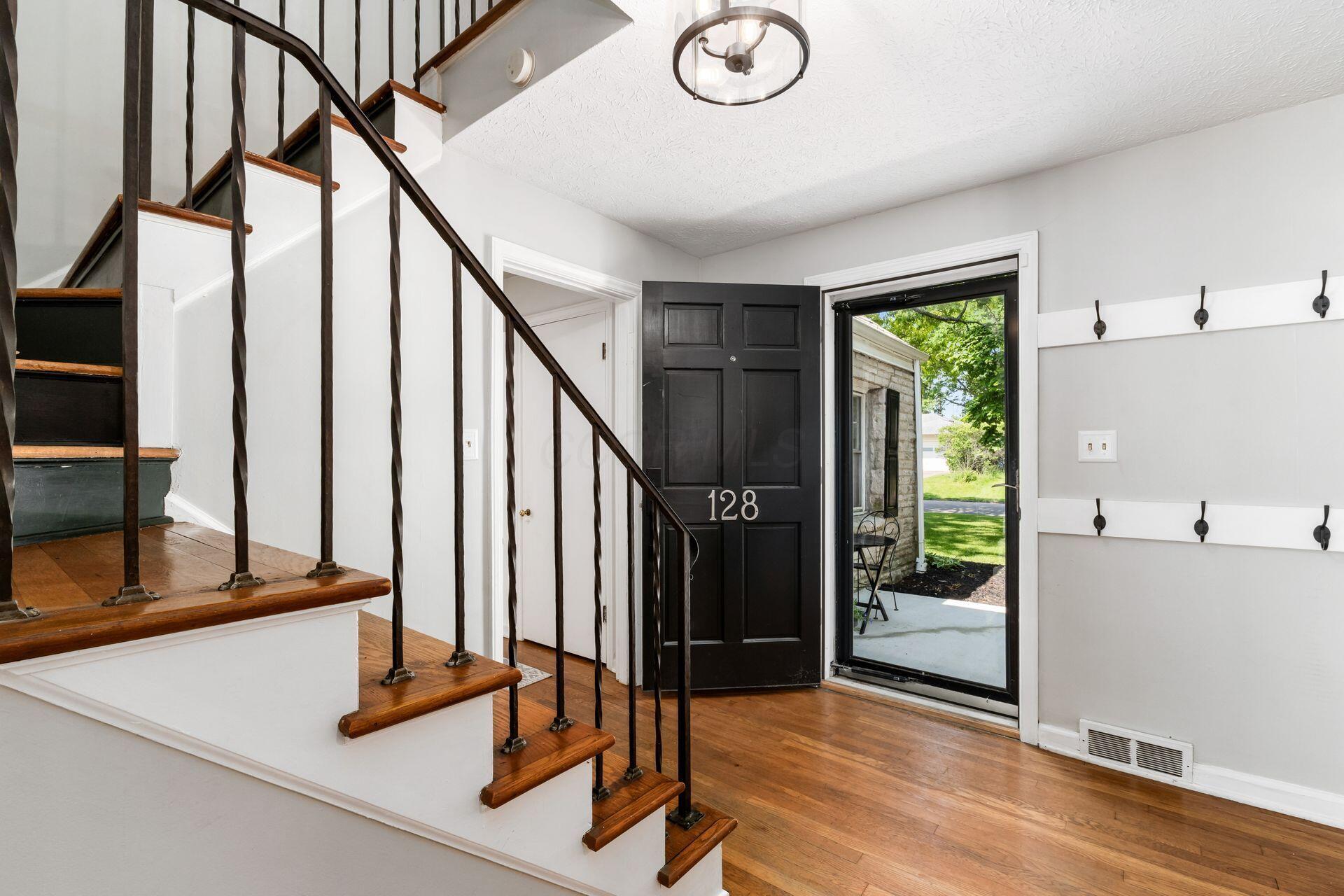 128 South Kellner Road Columbus, OH 43209 - Photo 7 of 53 Entry Foyer - 12'0" x 9'0" - Wood Floors, Coat Closet, Wrought Iron Railing