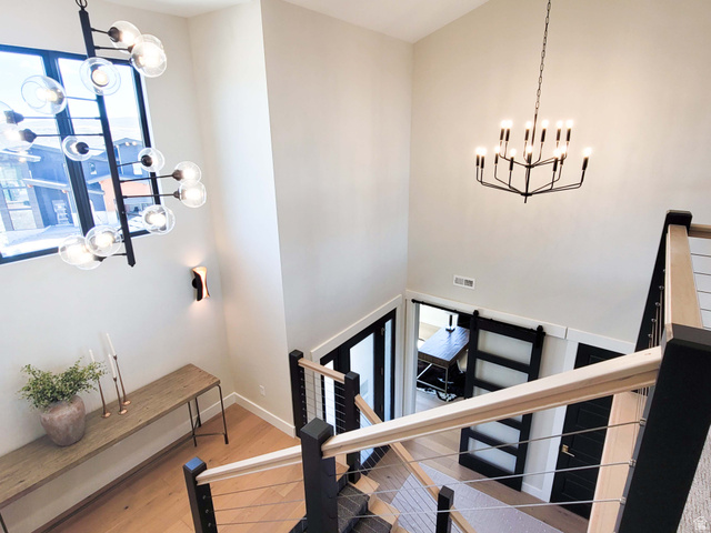1303 East Lasso Trail, Unit R6 Kamas, UT 84036 - Photo 23 of 31 High ceilings with contemporary chandeliers, wood-finish flooring, modern staircase with cable railing, and a barn door entry