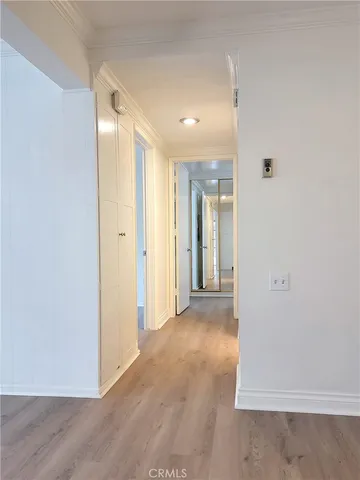 a view of a hallway with wooden floor