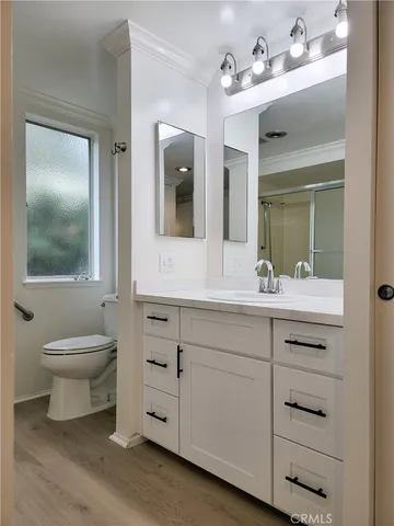 a bathroom with a glass shower door