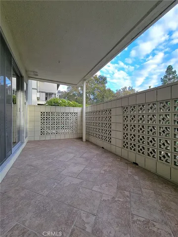 a view of a garage with white cabinets