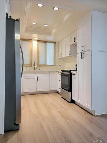 a large kitchen with cabinets and stainless steel appliances