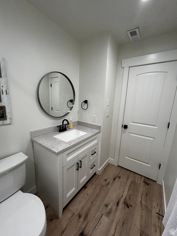 608 South 500 West, Unit 3 Provo, UT 84601 - Photo 24 of 35 Modern bathroom featuring a white vanity with shaker-style cabinetry, a speckled countertop, and a white undermount sink