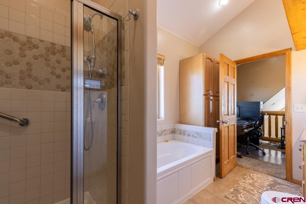1737 Roberts Ridge Drive Hesperus, CO 81326 - Photo 16 of 34 a bathroom with a tub shower and sink