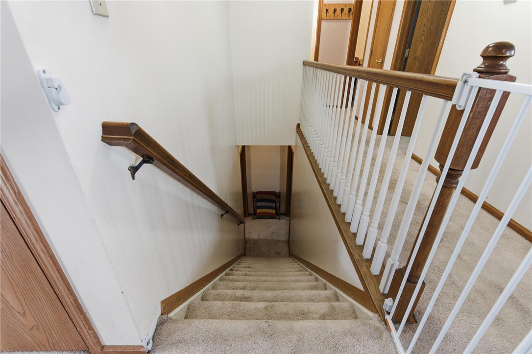 8747 Waynes Way Blanchester, OH 45107 - Photo 19 of 40 This interior staircase features carpet flooring, leading to a cozy lower level.