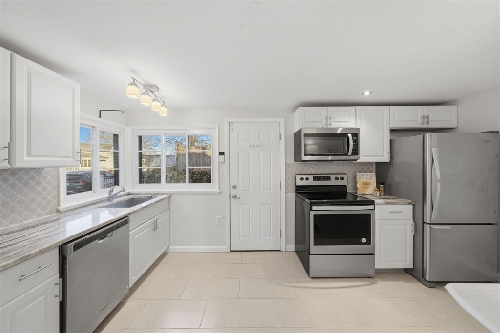 70 Farrell Road Lynn, MA 01905 - Photo 4 of 22 a kitchen with a refrigerator stove and microwave