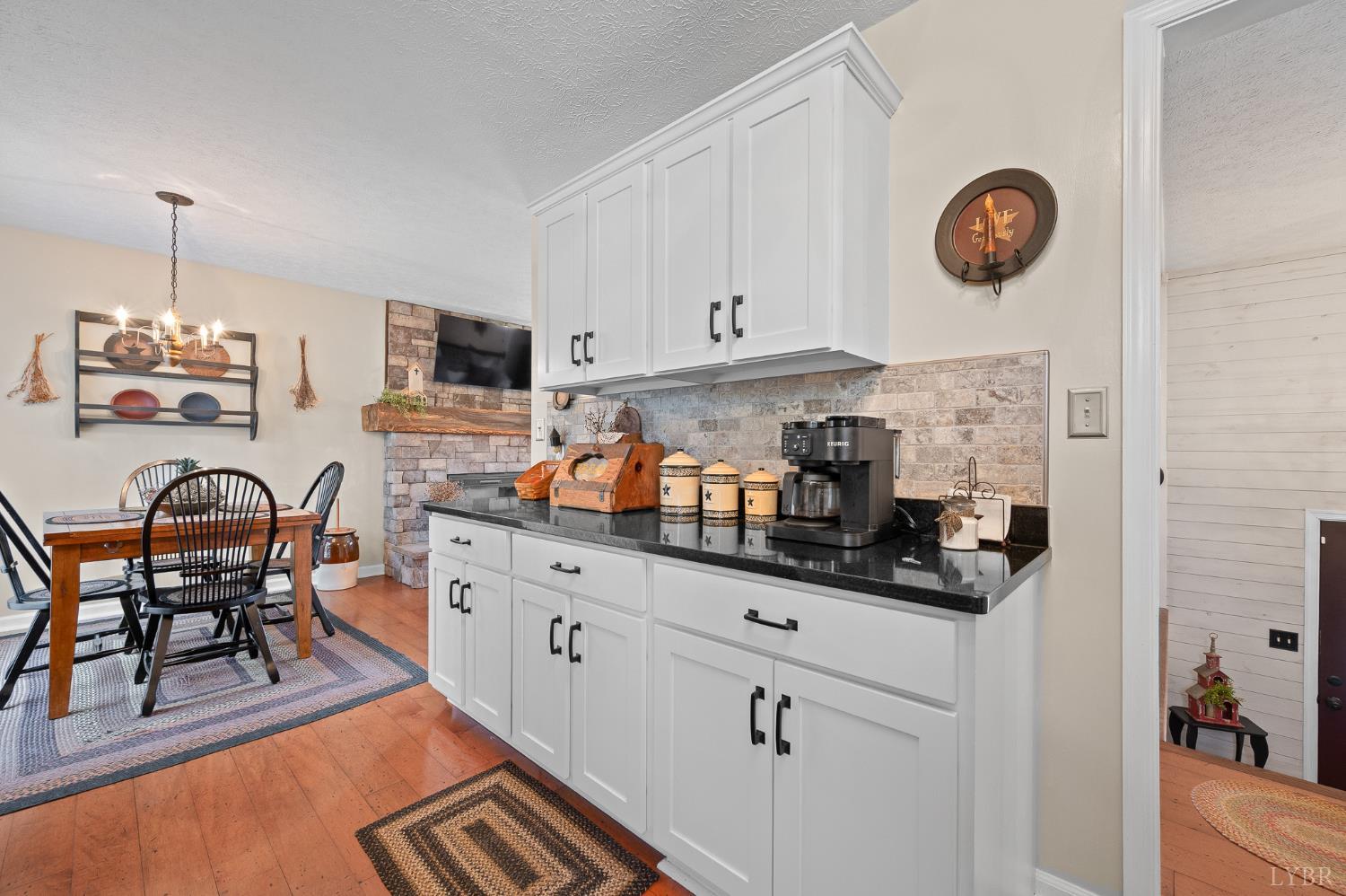 1136 Coolbrook Road Bedford, VA 24523 - Photo 14 of 46 a kitchen with stainless steel appliances granite countertop a stove a sink dishwasher and white cabinets with wooden floor