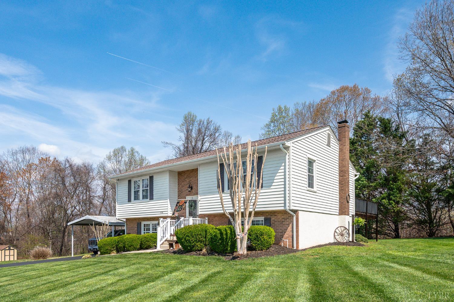 1136 Coolbrook Road Bedford, VA 24523 - Photo 2 of 46 a front view of a house with a garden and plants