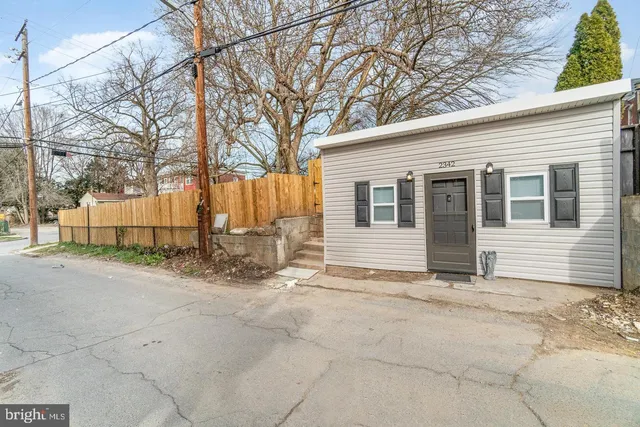 a view of a house with snow on the road