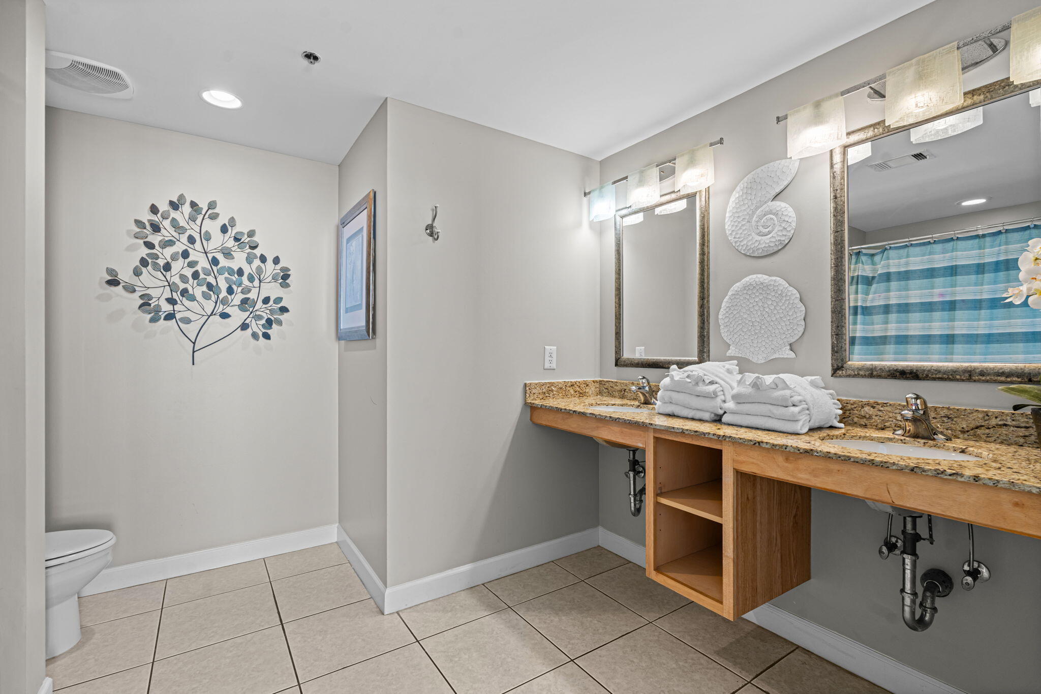17729 Front Beach Road, Unit 702E Panama City Beach, FL 32413 - Photo 25 of 53 a bathroom with a double vanity sink mirror and toilet