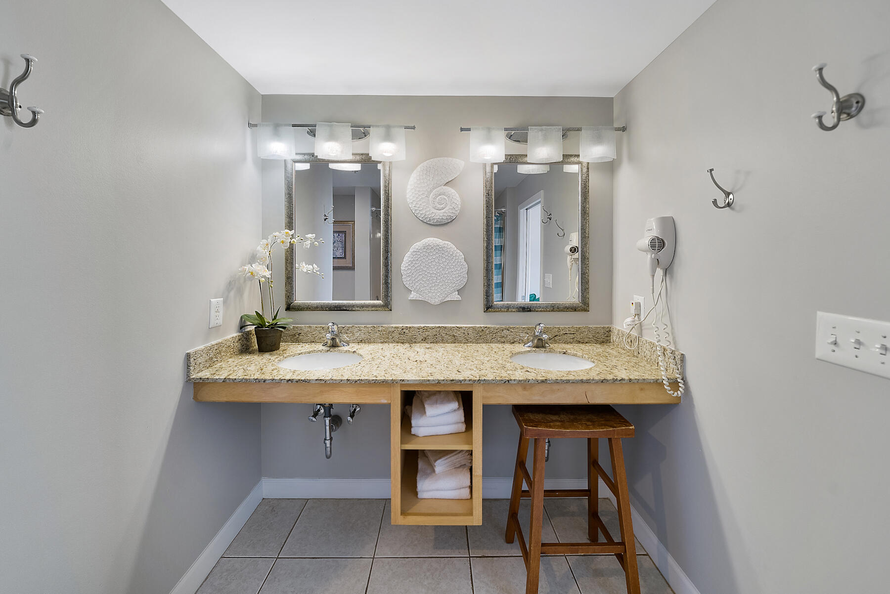17729 Front Beach Road, Unit 702E Panama City Beach, FL 32413 - Photo 35 of 53 a bathroom with a granite countertop sink a mirror and a vanity