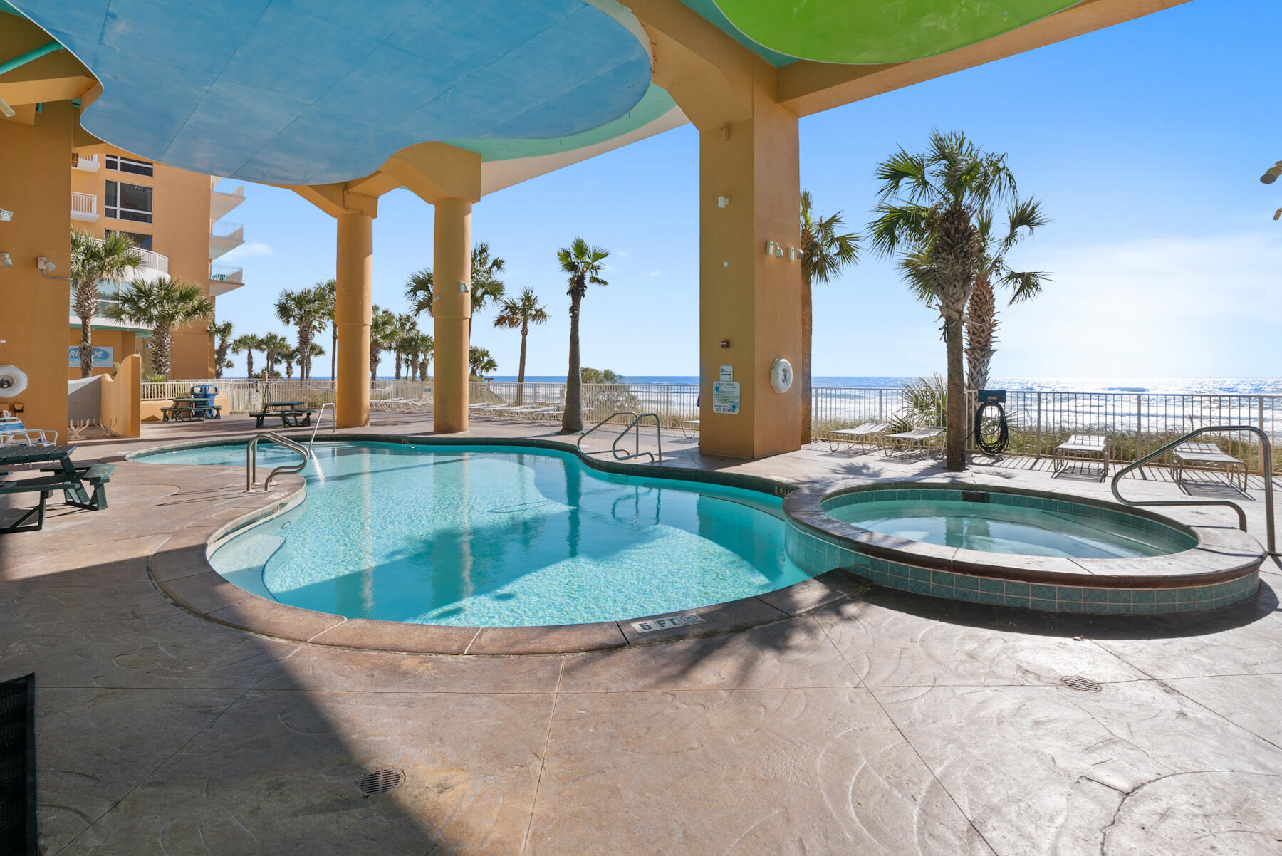 17729 Front Beach Road, Unit 702E Panama City Beach, FL 32413 - Photo 45 of 53 a view of a swimming pool with a lounge chair