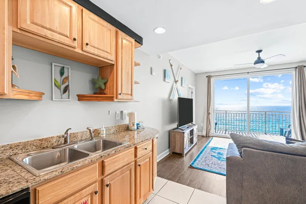a living room with furniture and a kitchen view