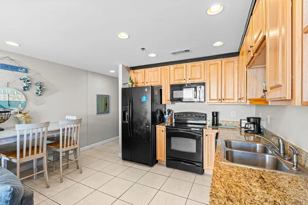 a kitchen with a sink a counter top space and stainless steel appliances