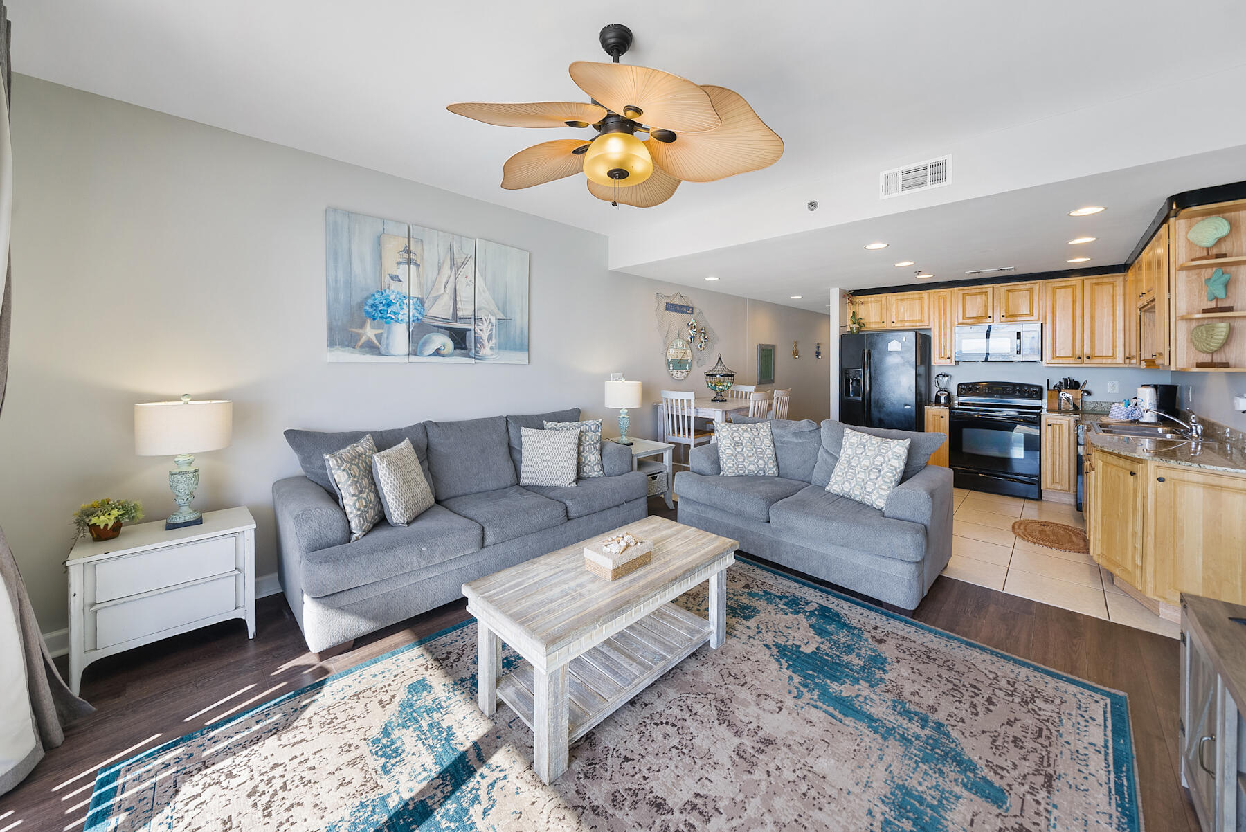 17729 Front Beach Road, Unit 702E Panama City Beach, FL 32413 - Photo 9 of 53 a living room with furniture kitchen view and a chandelier