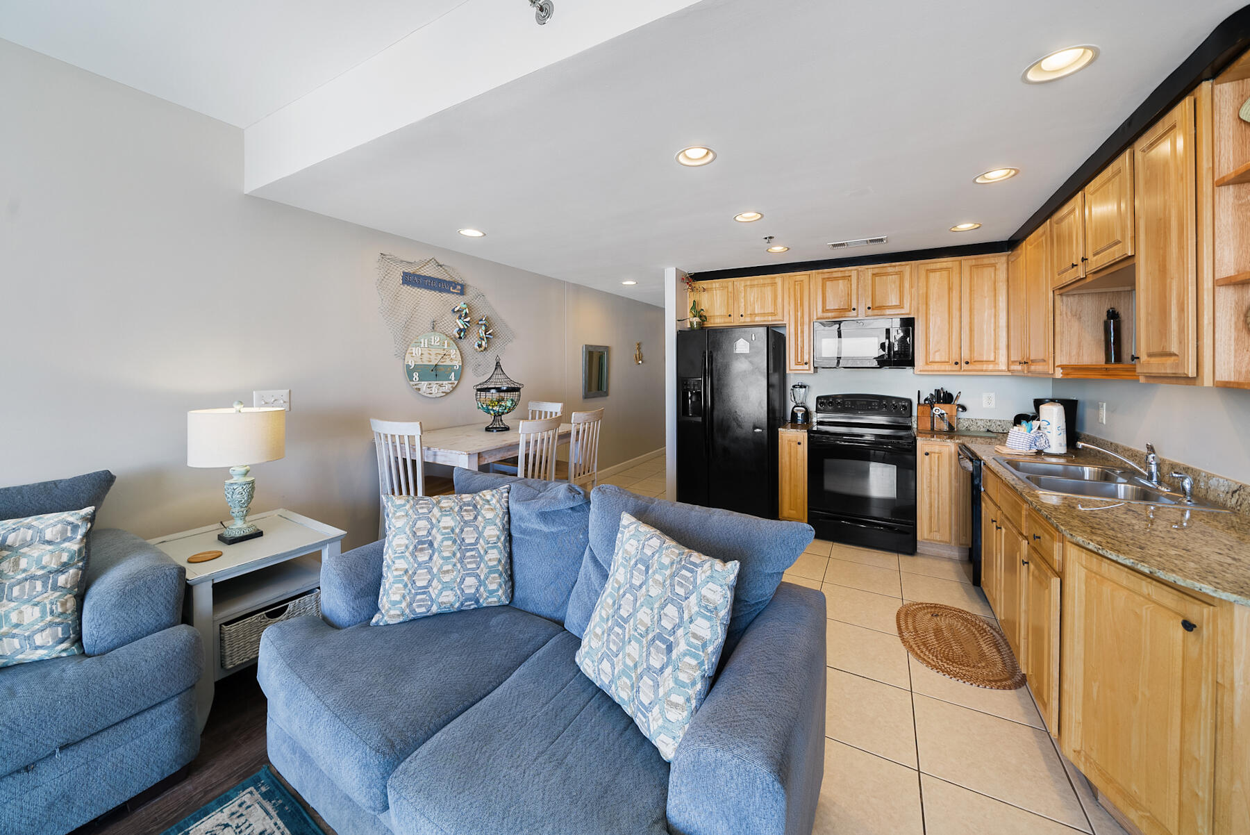 17729 Front Beach Road, Unit 702E Panama City Beach, FL 32413 - Photo 10 of 53 a living room with furniture and a kitchen view