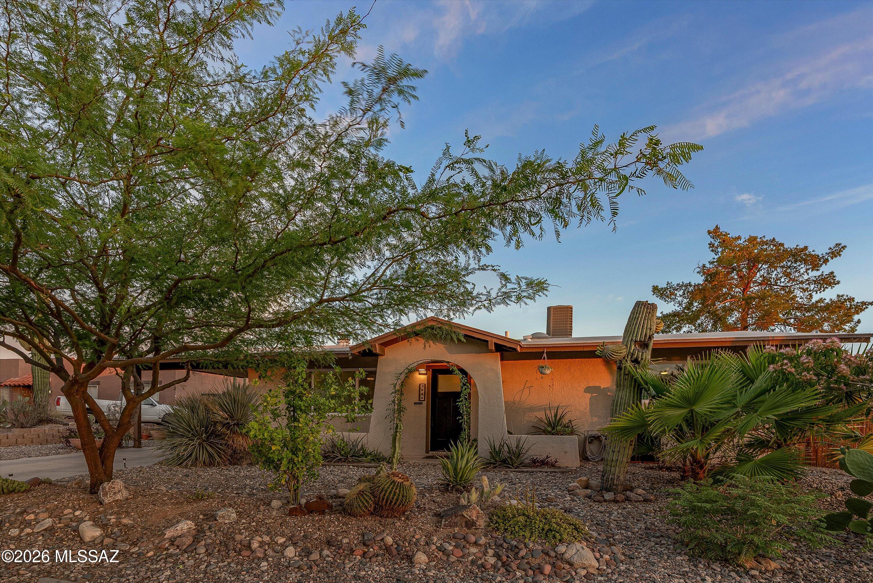3949 West Mars Street Tucson, AZ 85741 - Photo 1 of 27 a front view of a house with a yard