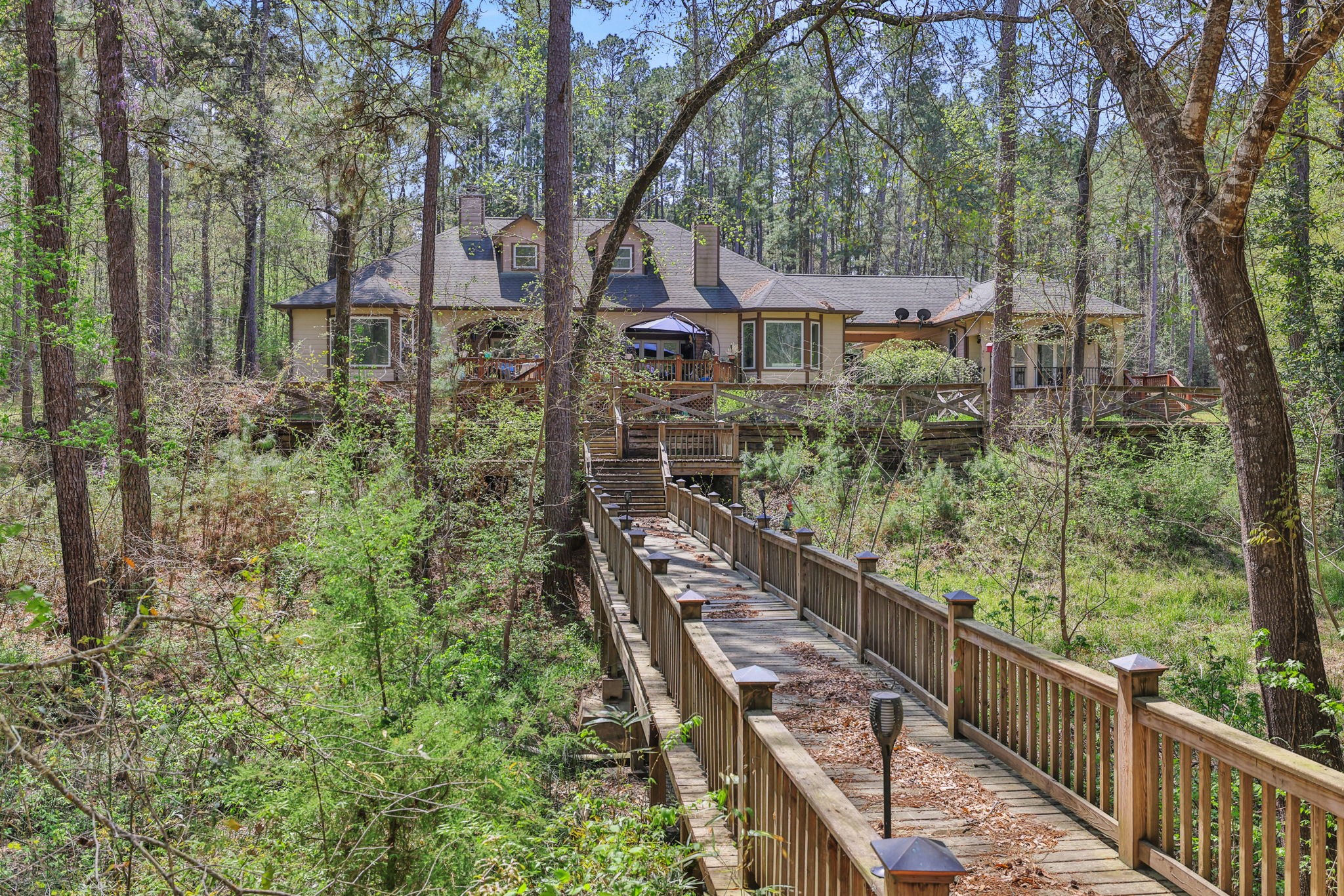 250 Critter Creek Road Coldspring, TX 77331 - Photo 20 of 48 Meander across the bridge to the pavilion