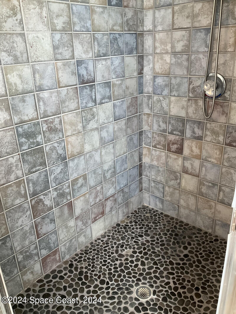 2035 Florida A1A, Unit 201 Satellite Beach, FL 32937 - Photo 12 of 12 a bathroom with a shower