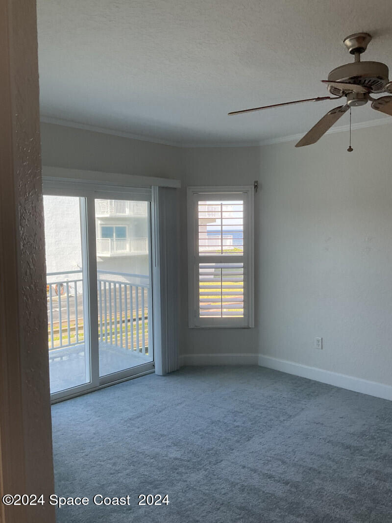 2035 Florida A1A, Unit 201 Satellite Beach, FL 32937 - Photo 4 of 12 a view of an empty room with a window
