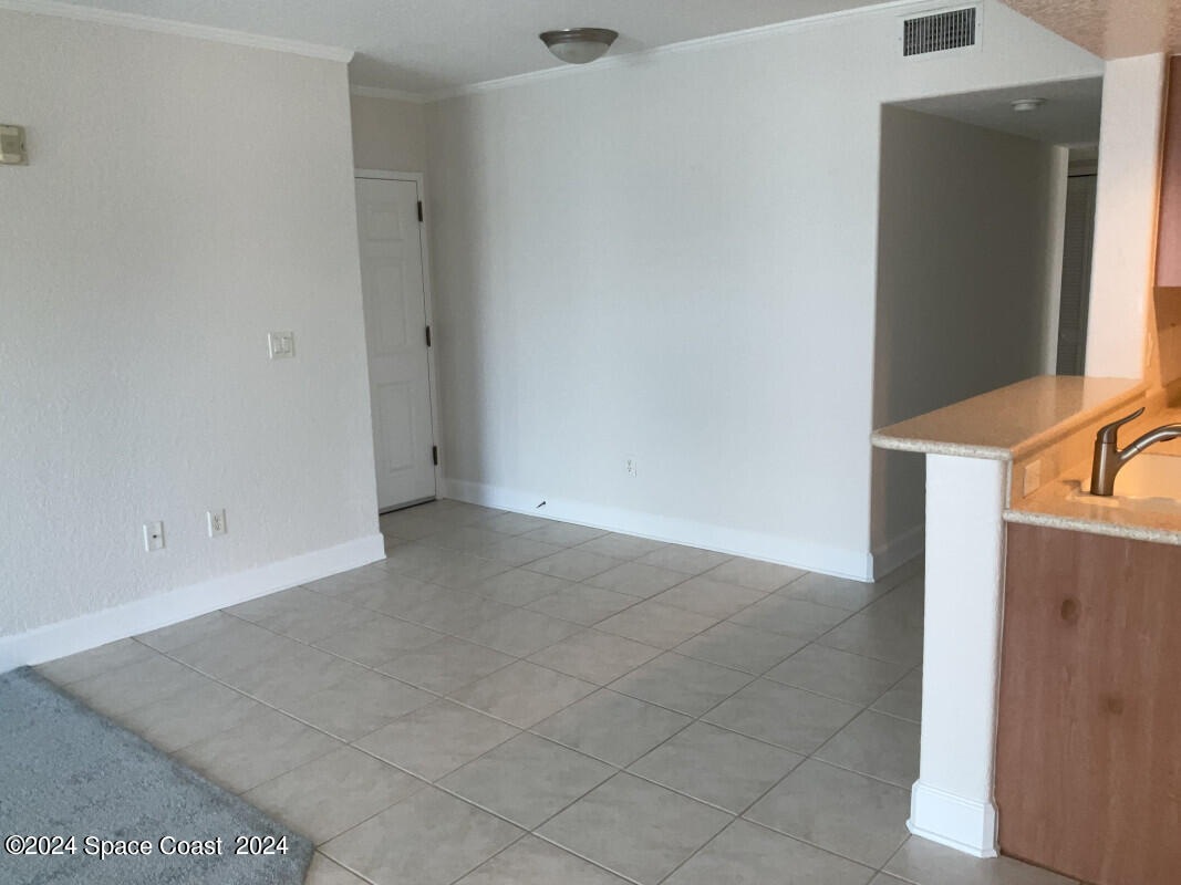 2035 Florida A1A, Unit 201 Satellite Beach, FL 32937 - Photo 6 of 12 an empty room with windows