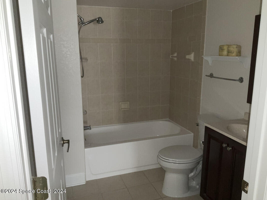 2035 Florida A1A, Unit 201 Satellite Beach, FL 32937 - Photo 6 of 12 a bathroom with a toilet and a shower