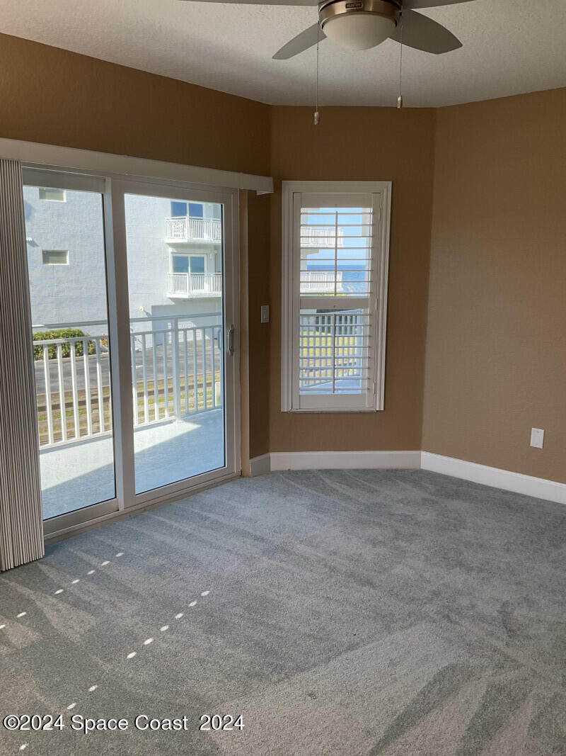 2035 Florida A1A, Unit 201 Satellite Beach, FL 32937 - Photo 10 of 12 a view of an empty room with a window