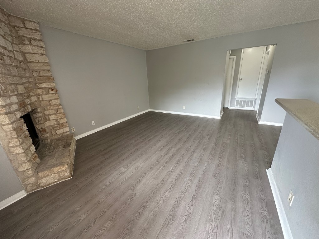 9808 Roxanna Drive, Unit D Austin, TX 78748 - Photo 2 of 12 wooden floor in an empty room with a fireplace
