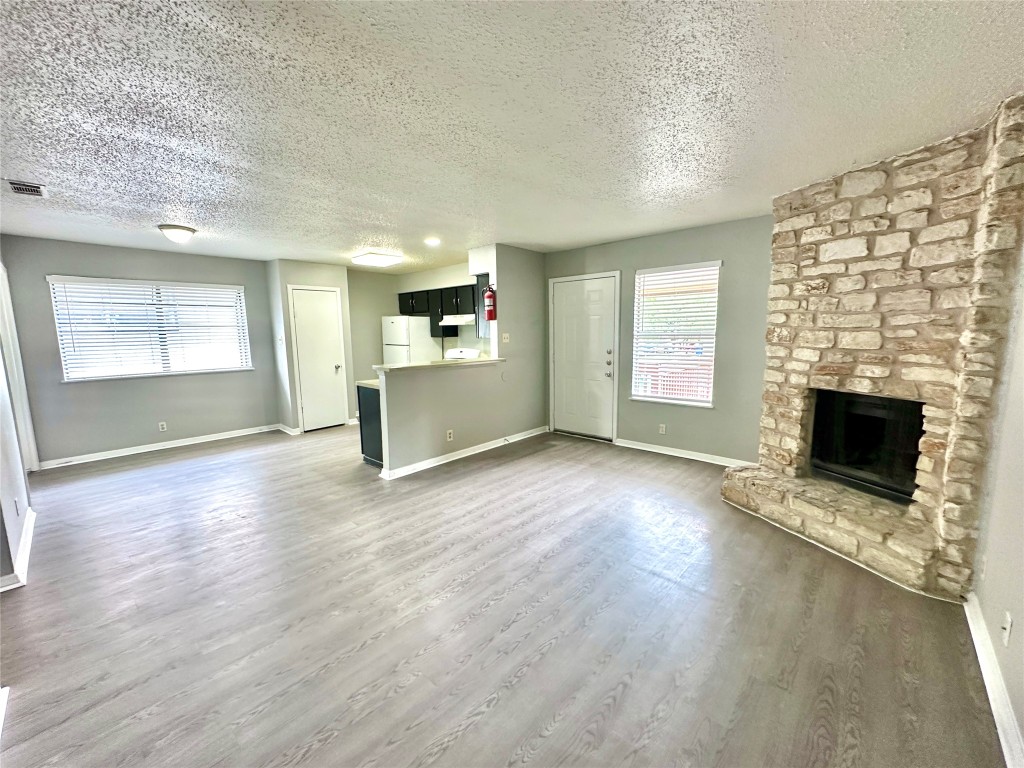 9808 Roxanna Drive, Unit D Austin, TX 78748 - Photo 3 of 12 an empty room with windows and fireplace