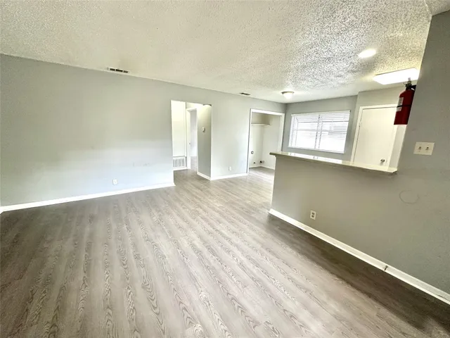 a view of a room with wooden floor and window
