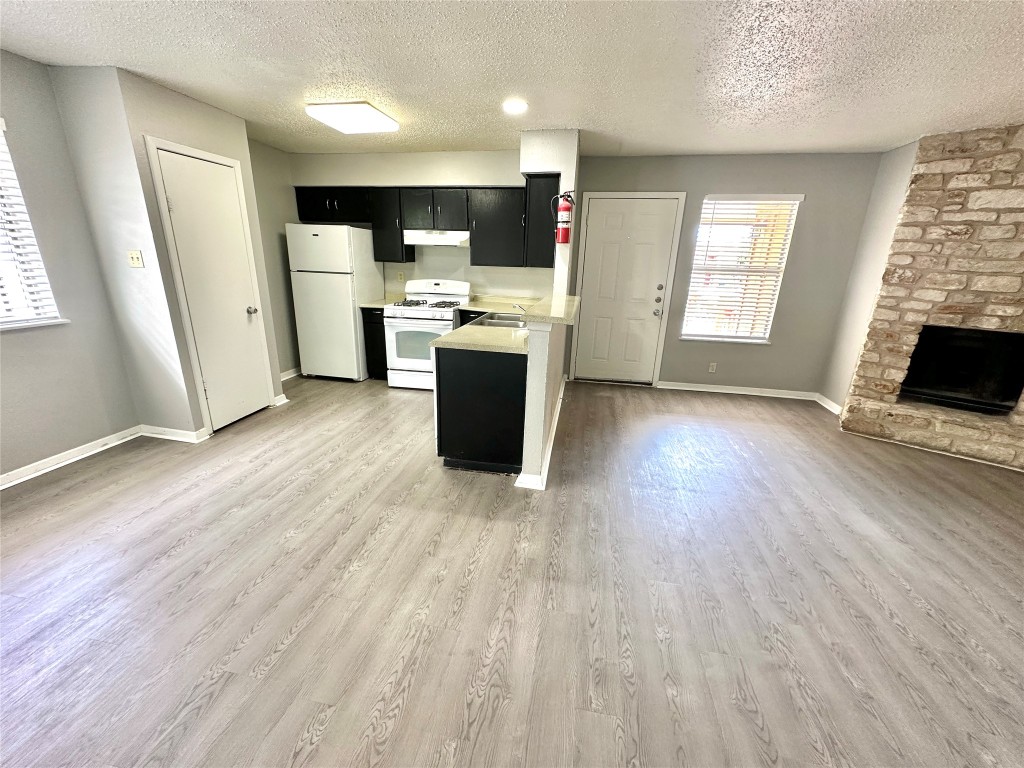 9808 Roxanna Drive, Unit D Austin, TX 78748 - Photo 11 of 12 a view of kitchen with refrigerator stove and wooden floor