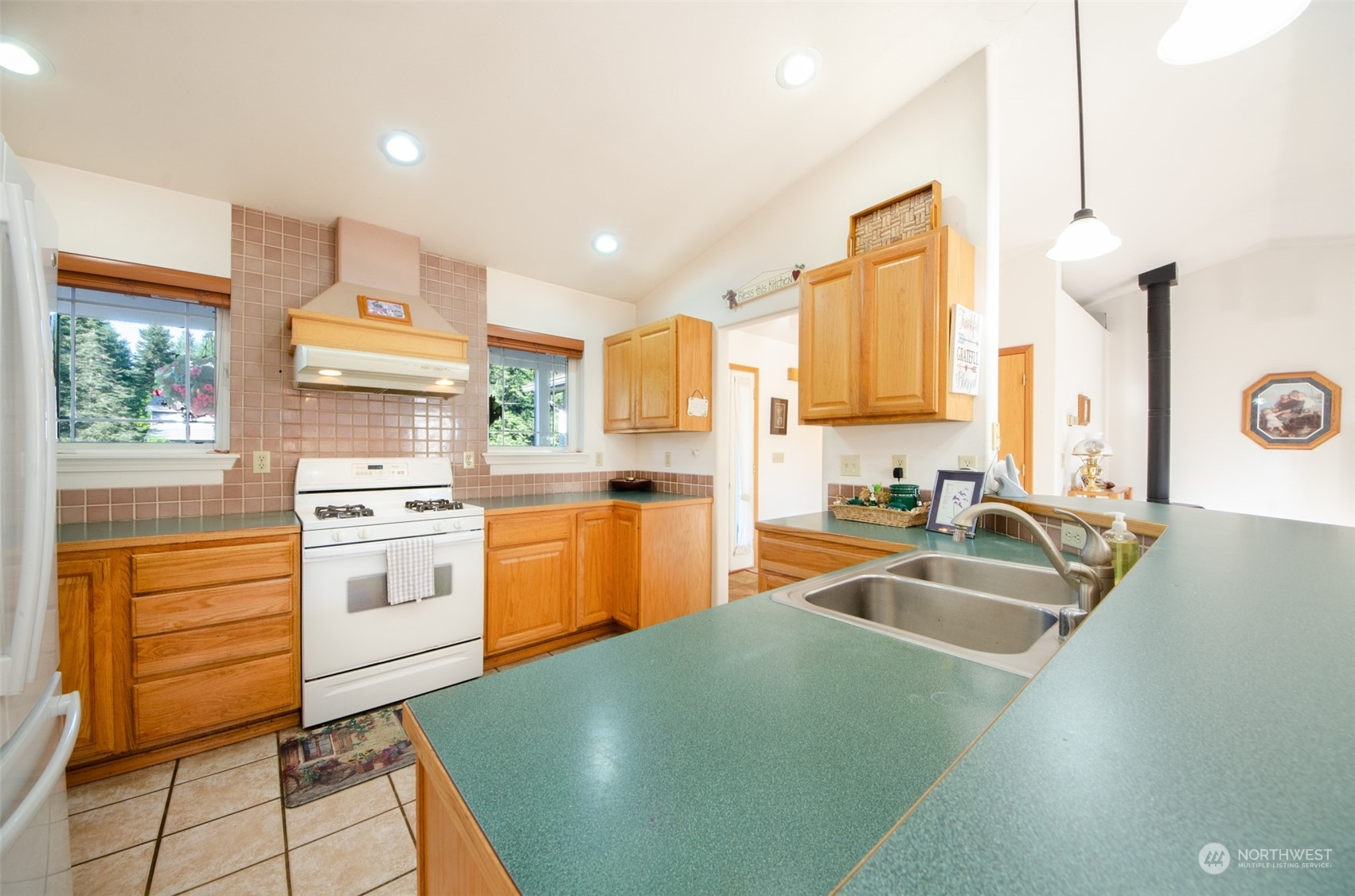 8203 177th Lane Southwest Rochester, WA 98579 - Photo 4 of 30 a kitchen with a sink stove and refrigerator