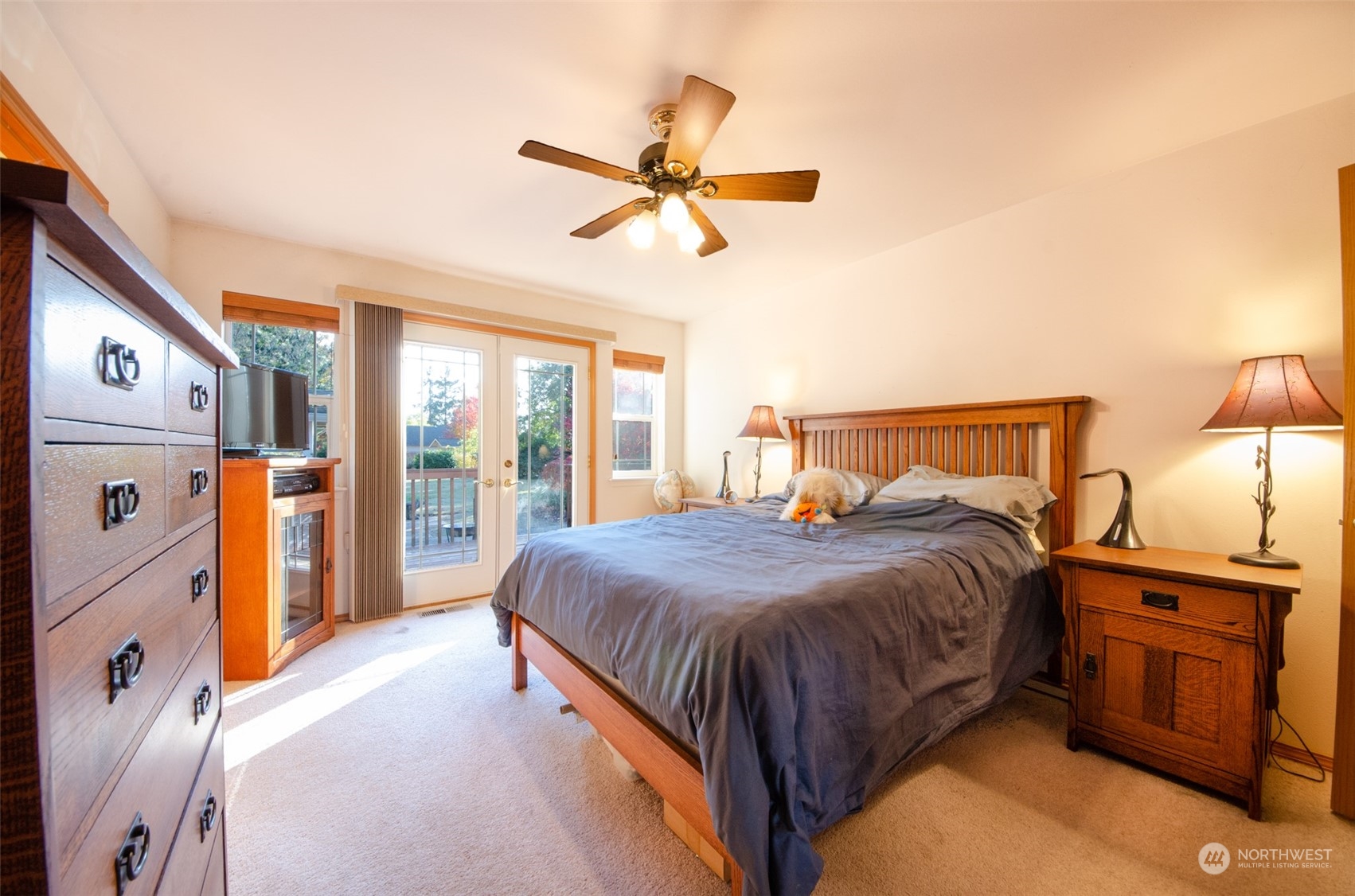 8203 177th Lane Southwest Rochester, WA 98579 - Photo 8 of 30 a bedroom with a bed and a chandelier