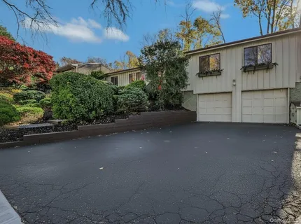 a view of a street with a cars parked in front of it