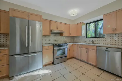 a view of empty room with wooden floor and fireplace