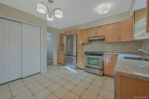a kitchen with a refrigerator sink and cabinets
