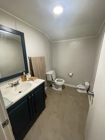 a bathroom with a sink vanity and a mirror