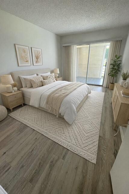 2075 Cornwall East, Unit 2075 Boca Raton, FL 33434 - Photo 12 of 32 a bedroom with a large bed and a large window