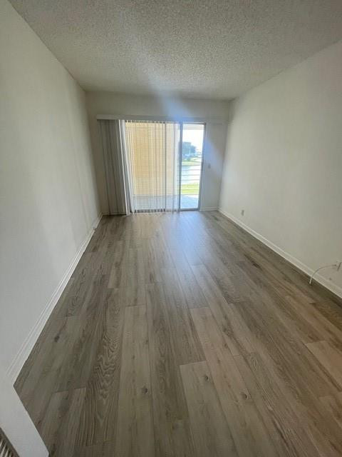 2075 Cornwall East, Unit 2075 Boca Raton, FL 33434 - Photo 13 of 32 wooden floor in an empty room with a window