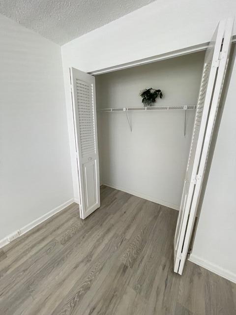 2075 Cornwall East, Unit 2075 Boca Raton, FL 33434 - Photo 18 of 32 an empty room with wooden floor and closet