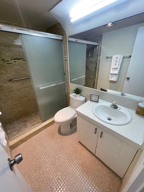 2075 Cornwall East, Unit 2075 Boca Raton, FL 33434 - Photo 19 of 32 a bathroom with a sink toilet and shower