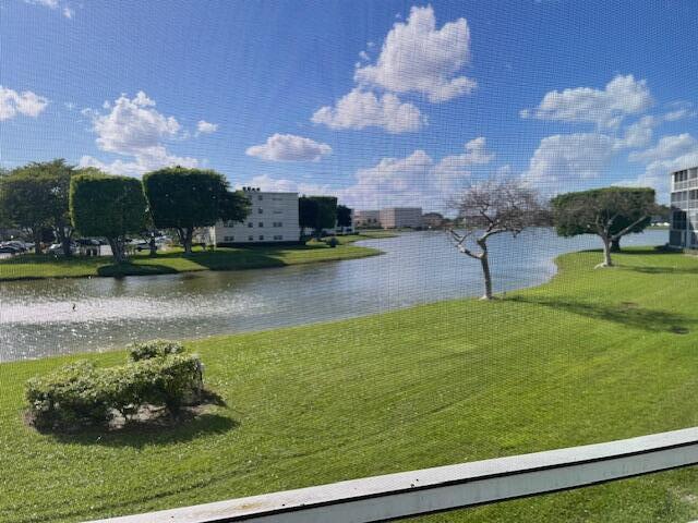 2075 Cornwall East, Unit 2075 Boca Raton, FL 33434 - Photo 27 of 32 a swimming pool with an outdoor seating