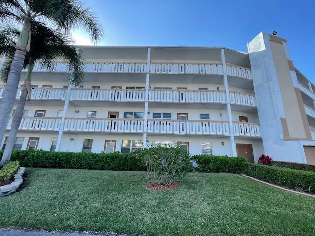 2075 Cornwall East, Unit 2075 Boca Raton, FL 33434 - Photo 3 of 32 a view of a building with a yard
